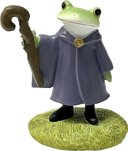 Frog figurine wearing a blue robe and holding a wizard staff on a white background