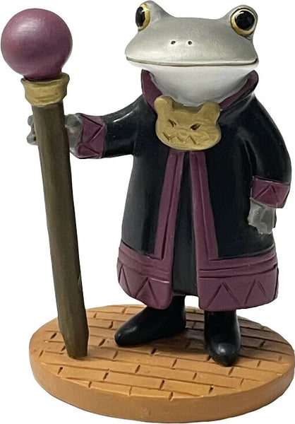 Frog in a black robe with a purple details holding a staff on a wooden base.
