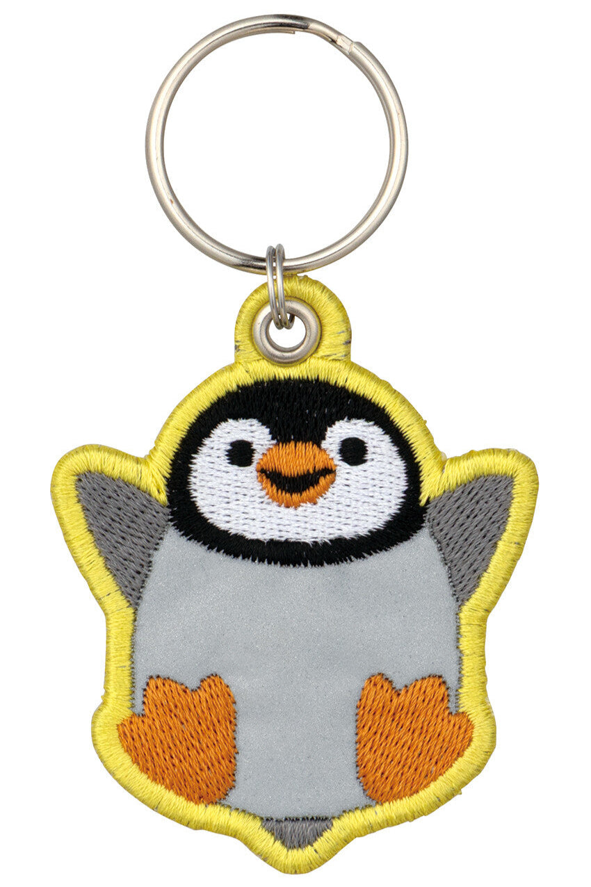 Penguin-shaped keychain with a metal ring on a white background