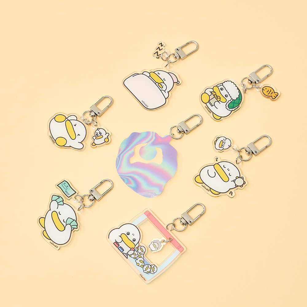 Collection of cartoon character keychains on a beige background