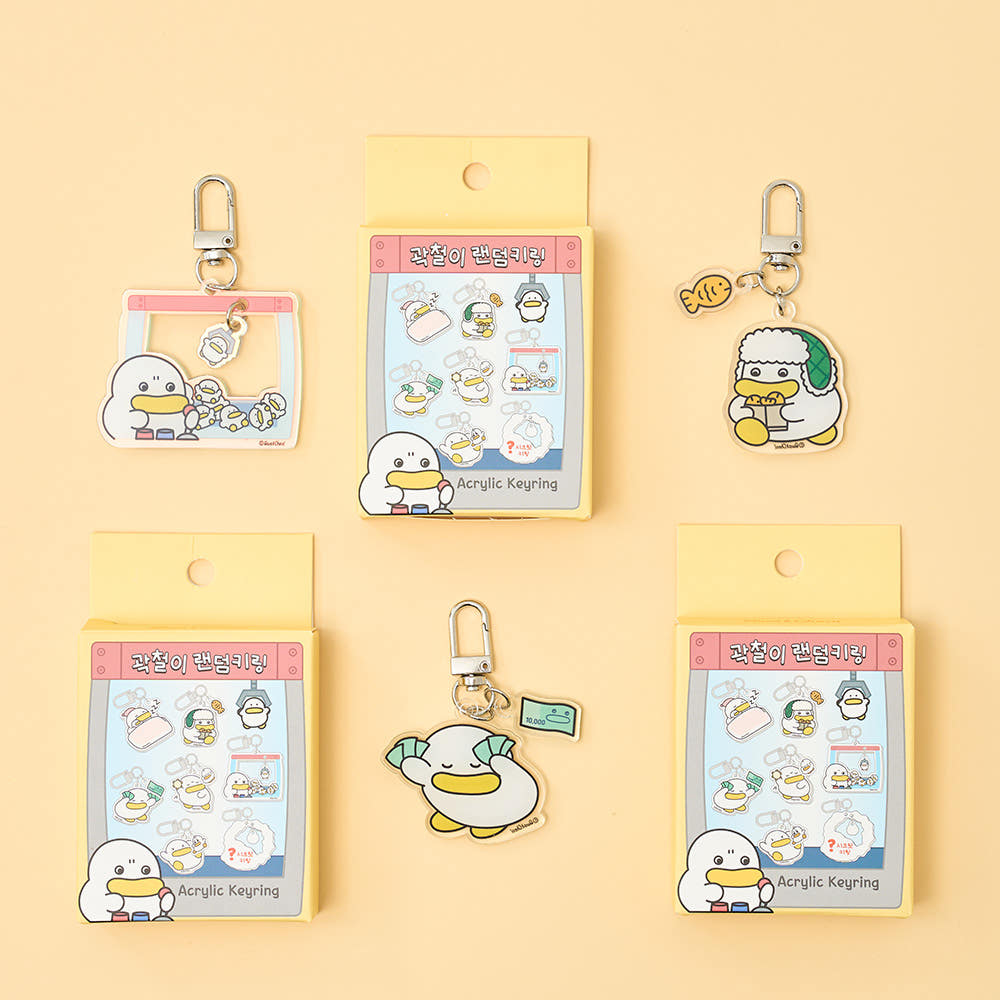 Acrylic keyrings with cartoon duck design on a yellow background