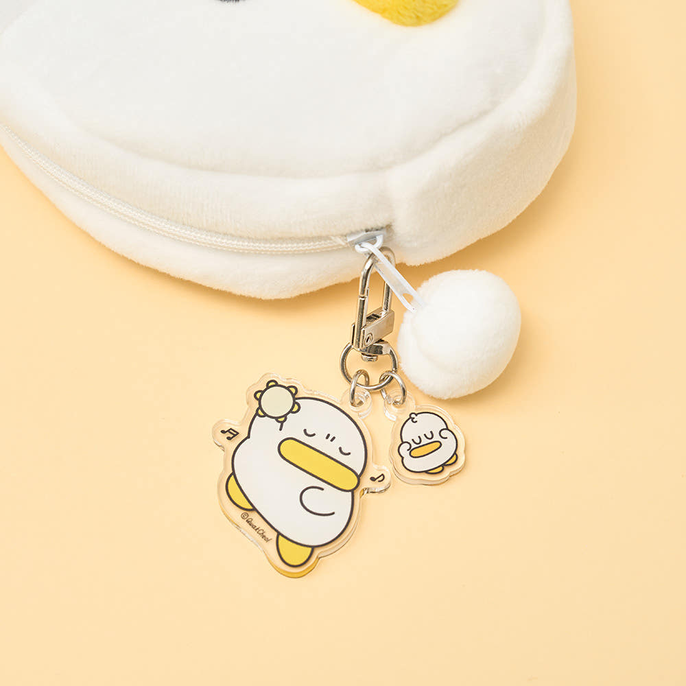 Keychain charm with cartoon character on a yellow background