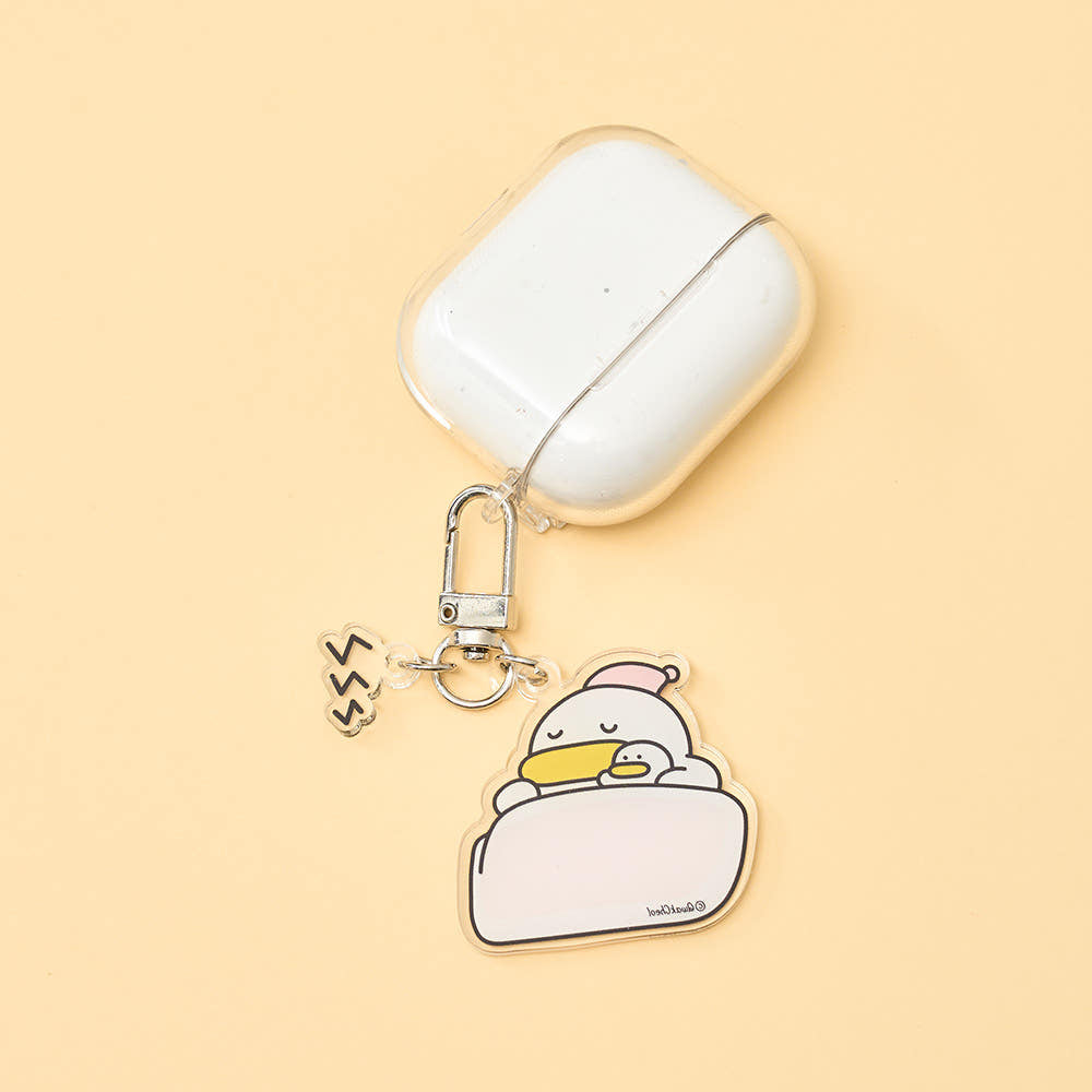 White air pod case with a cartoon character charm on a beige background