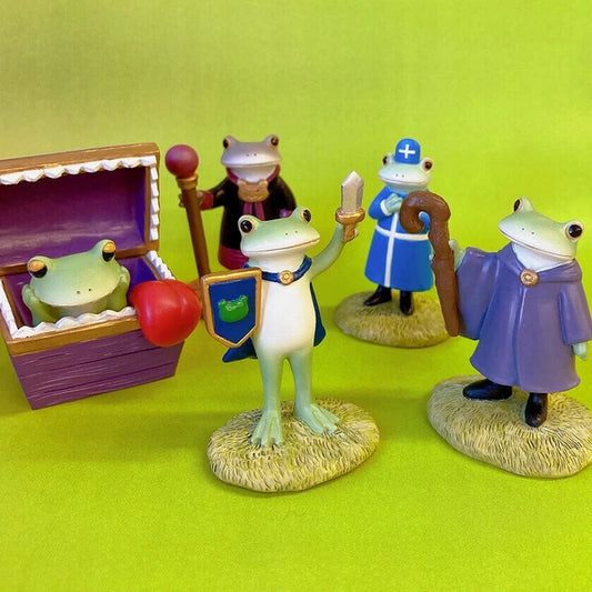Frog figurines with various accessories on a green background