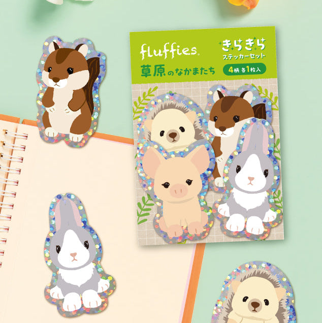 Set of animal-themed stickers with packaging on a green background