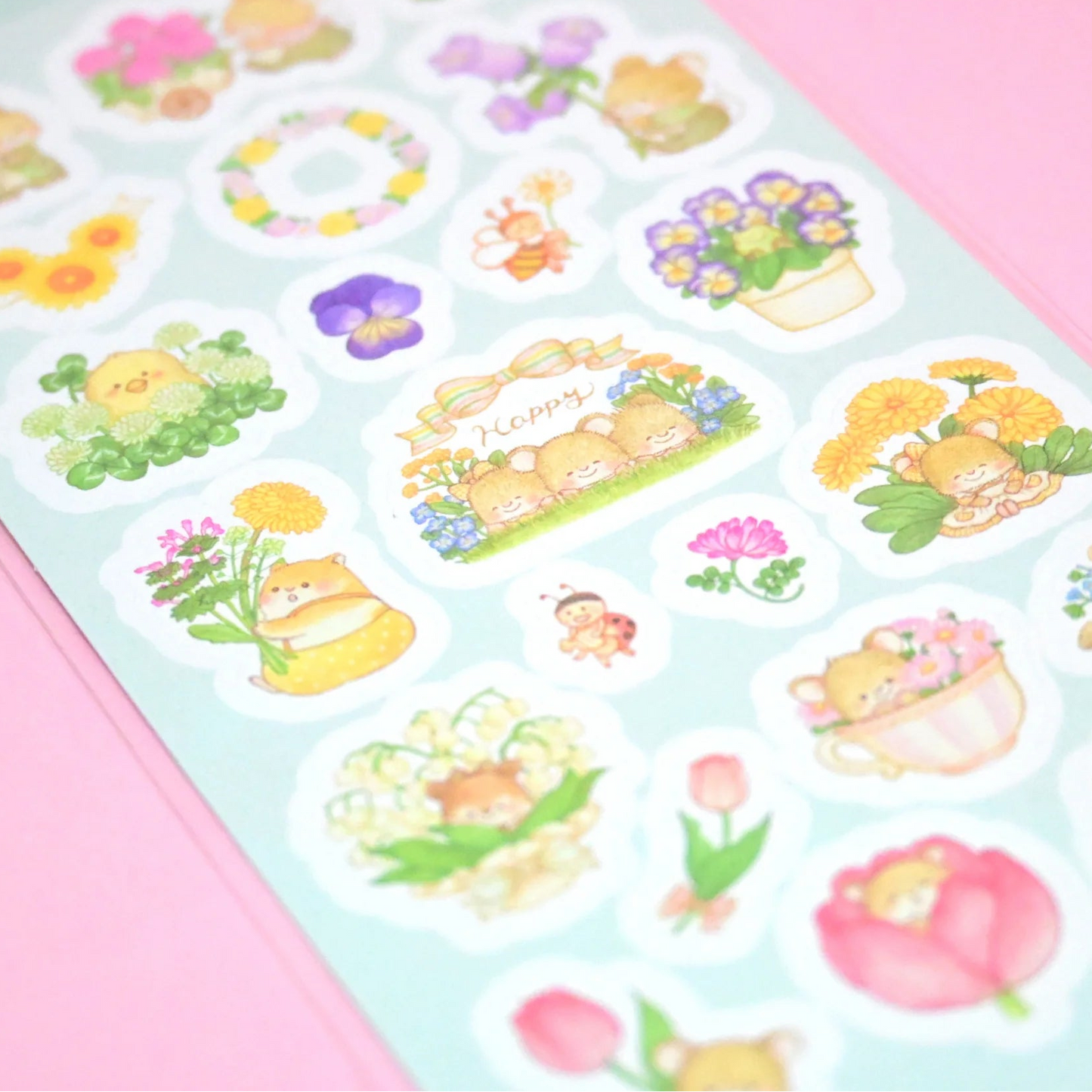 Sheet of decorative stickers with cartoon characters and flowers on a pink background
