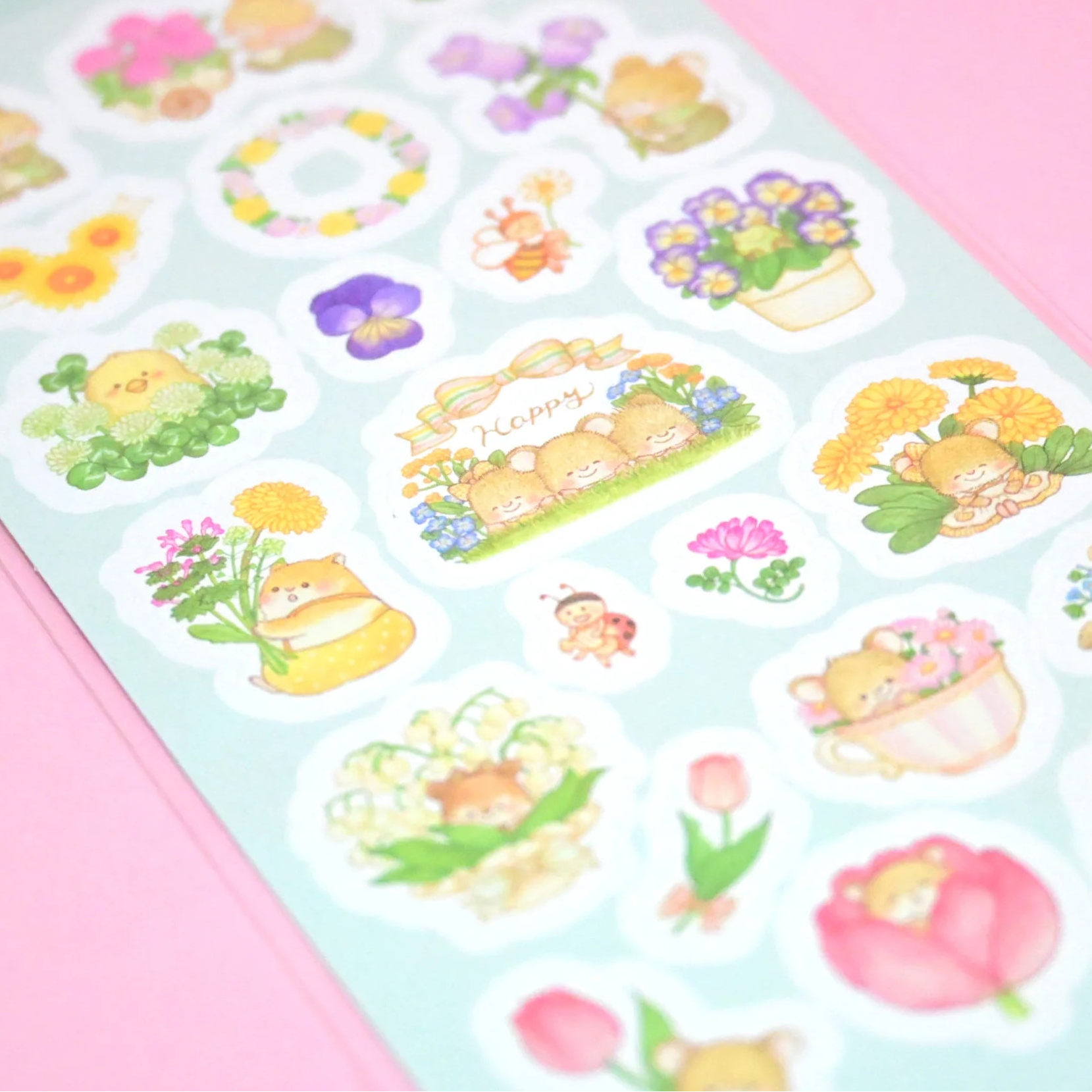 Sheet of decorative stickers with cartoon characters and flowers on a pink background